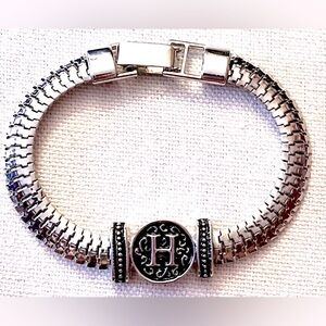 EUC SILVER COLORED LINK CHAIN BRACELET WITH MONOGRAM H AND FILIGREE IN CENTER